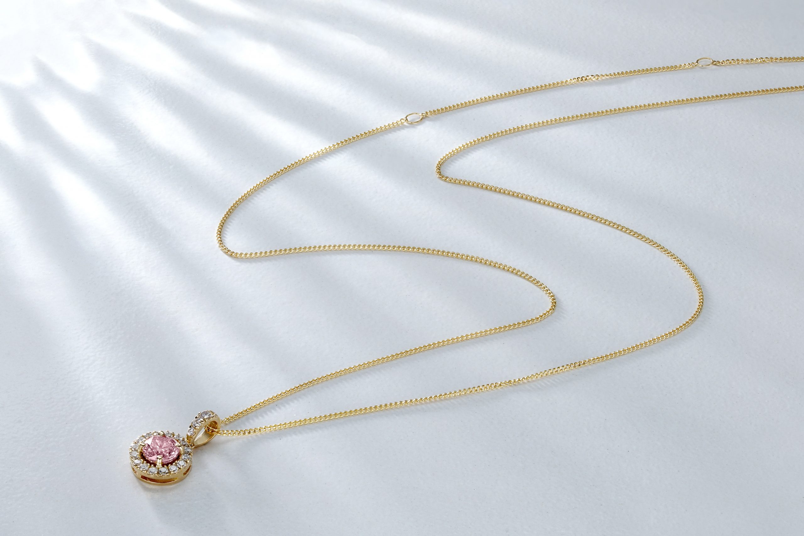 Gold necklace with pink stone